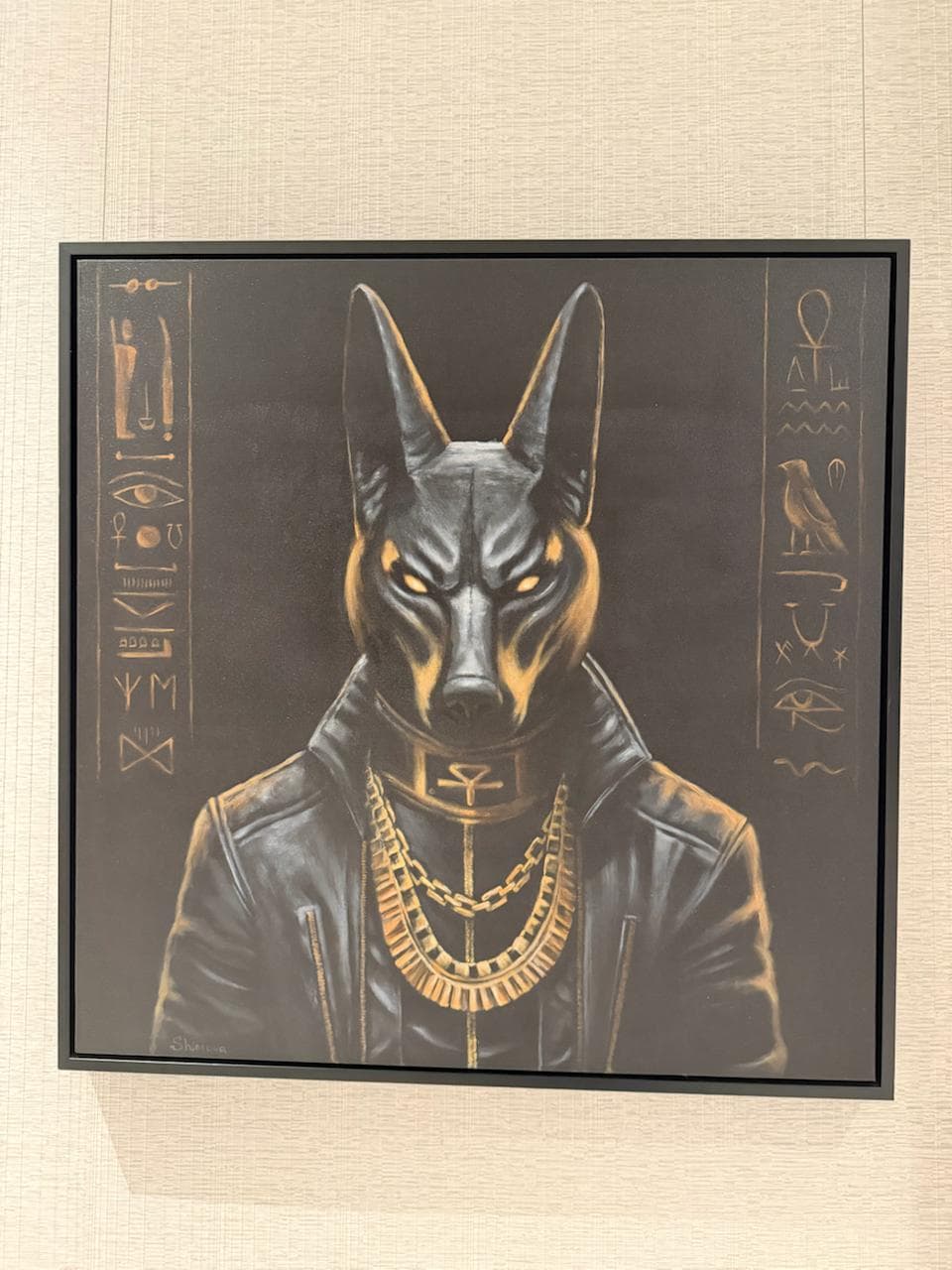 ANUBIS by Shimova, a framed acrylic painting of a jackal-headed Anubis figure with gold accents and hieroglyphic markings against a dark ground.