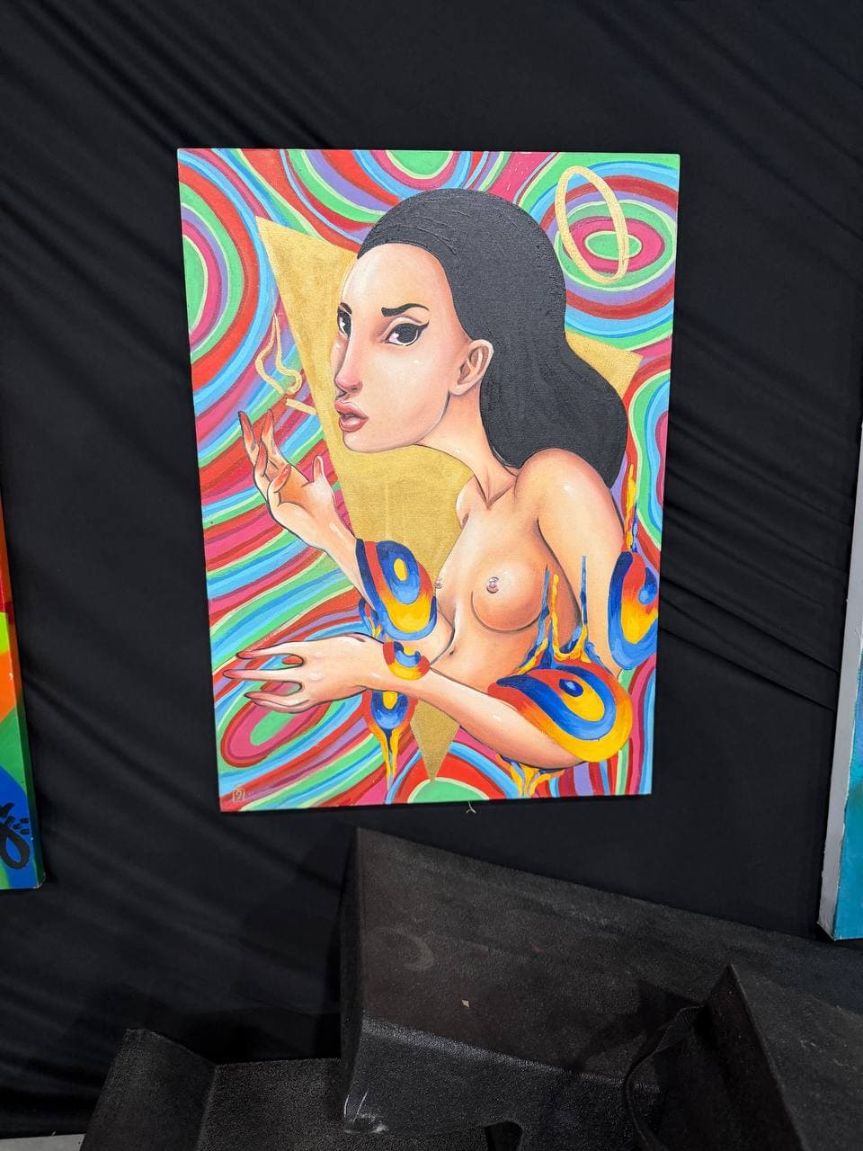 9Juane$ artwork Genesis showing a stylized female figure against rainbow optical bands, gold geometry, and blue-yellow arm accents.