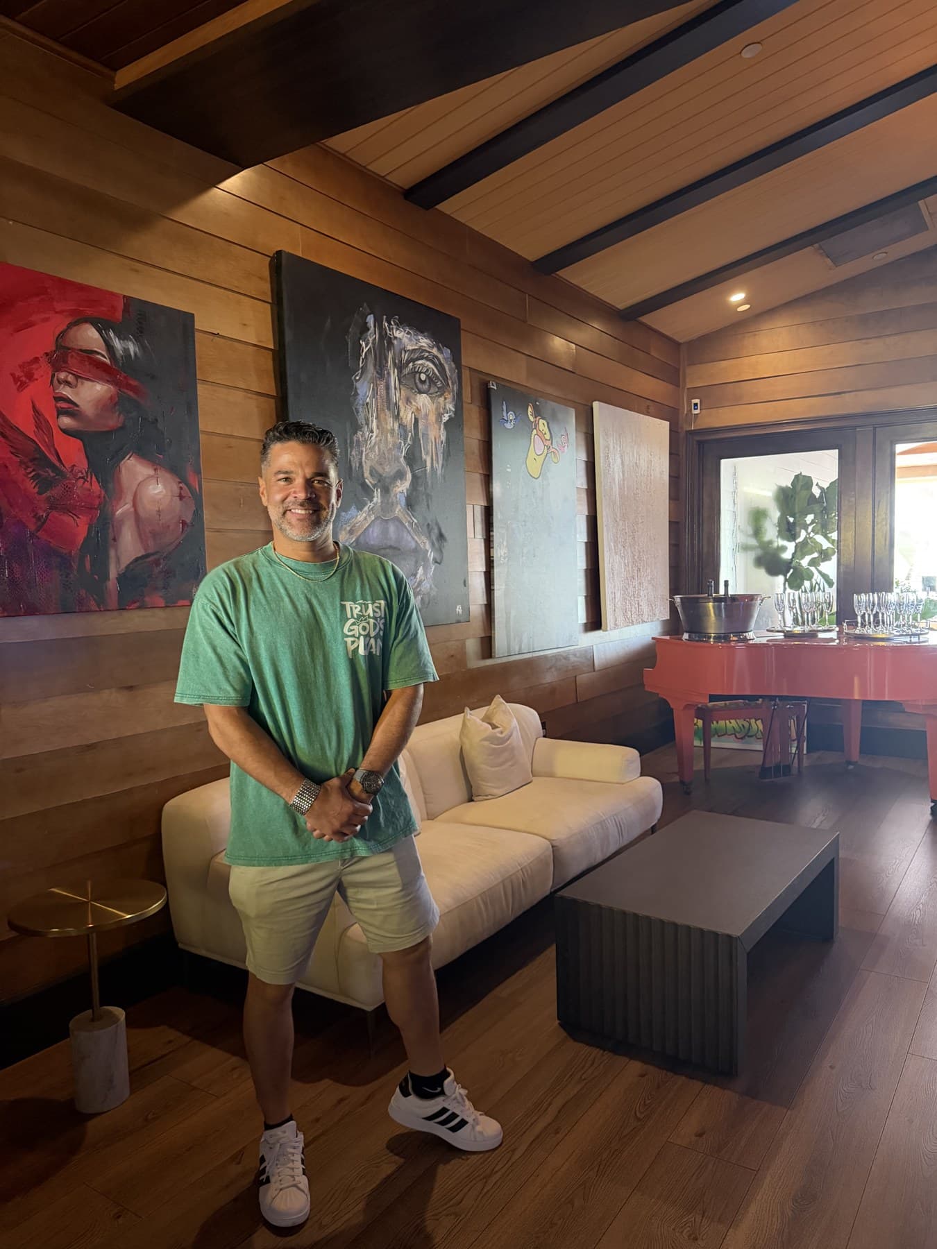 Jason Perez in front of artwork at the Rusty Pelican